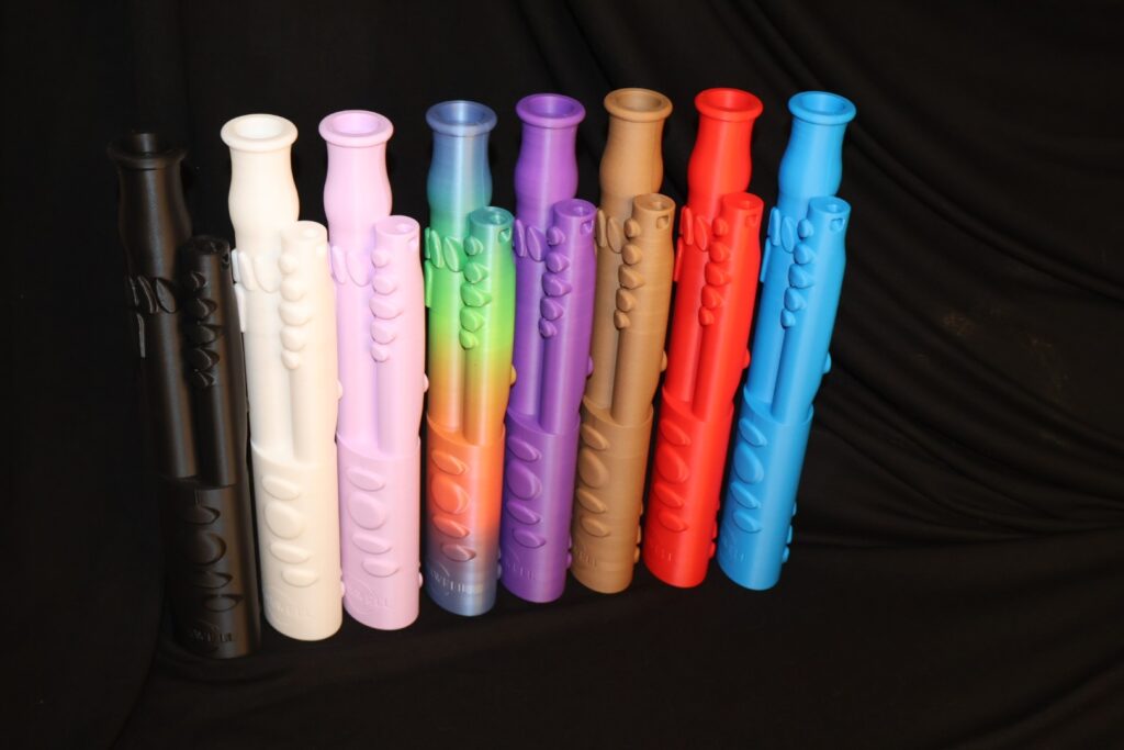 Multicolored prototypes of "The Bassoon Buddy". White, pink, rainbow, purple, brown, red, and blue options