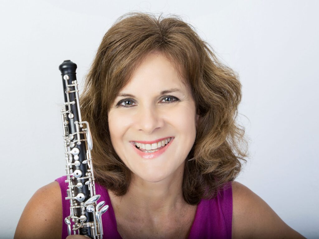 Headshot of a woman holding an oboe